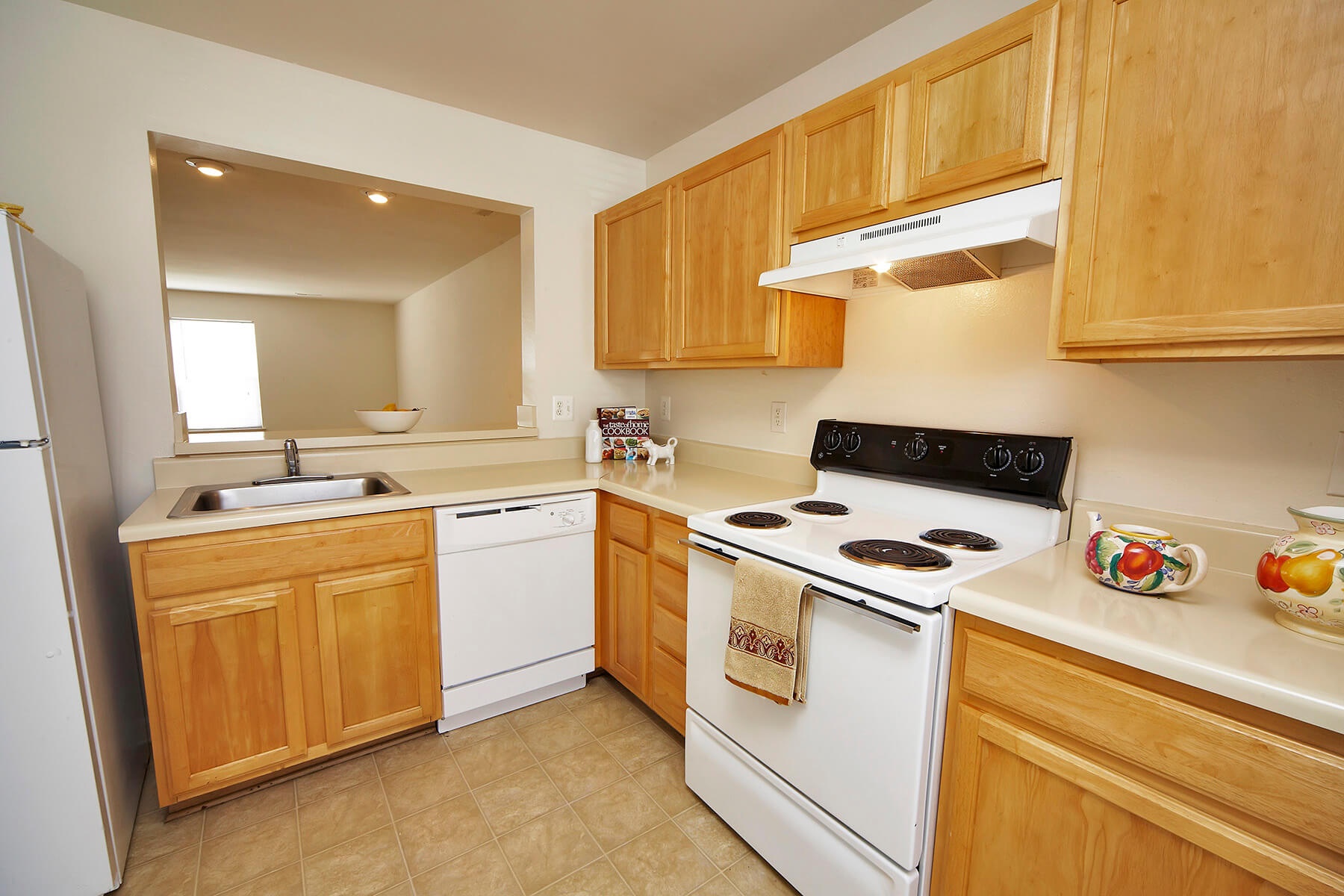 A bright kitchen with white appliances at the Broadwater Townhomes in Chester, Virginia.