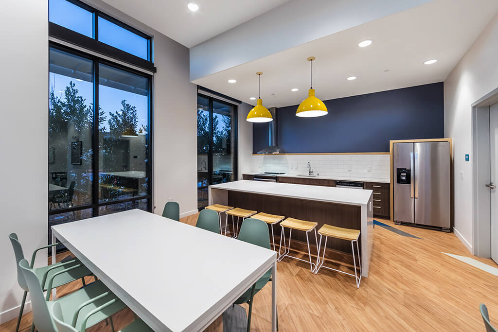 A spacious, modern kitchen with a kitchen island at the GEO Apartments in Fremont, California.